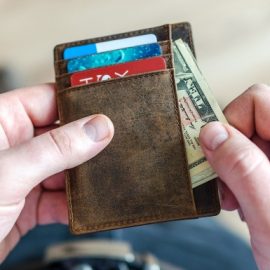 A person taking out money from wallet